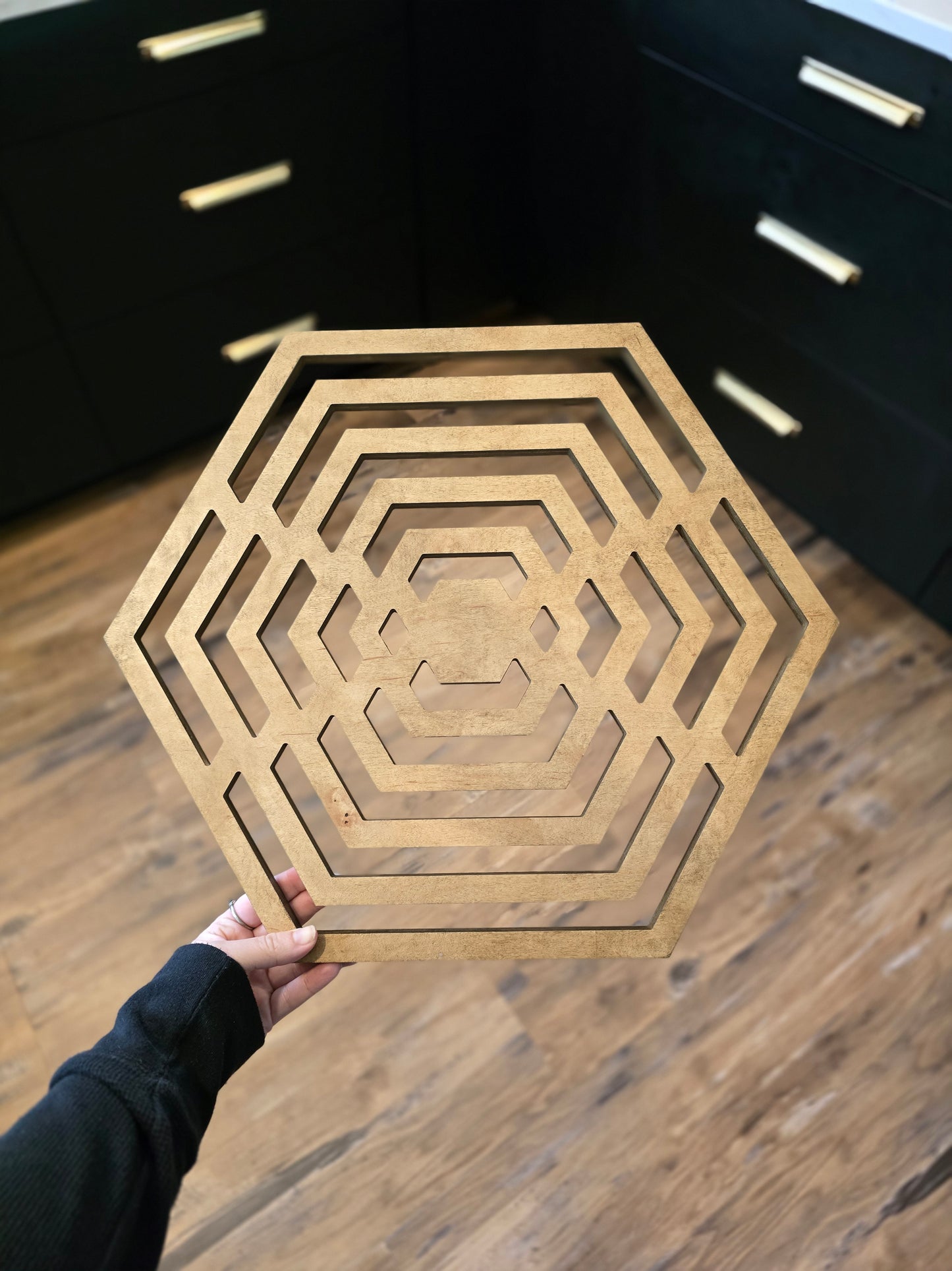 Hexagon-shaped geometric wood wall art in weathered stain.