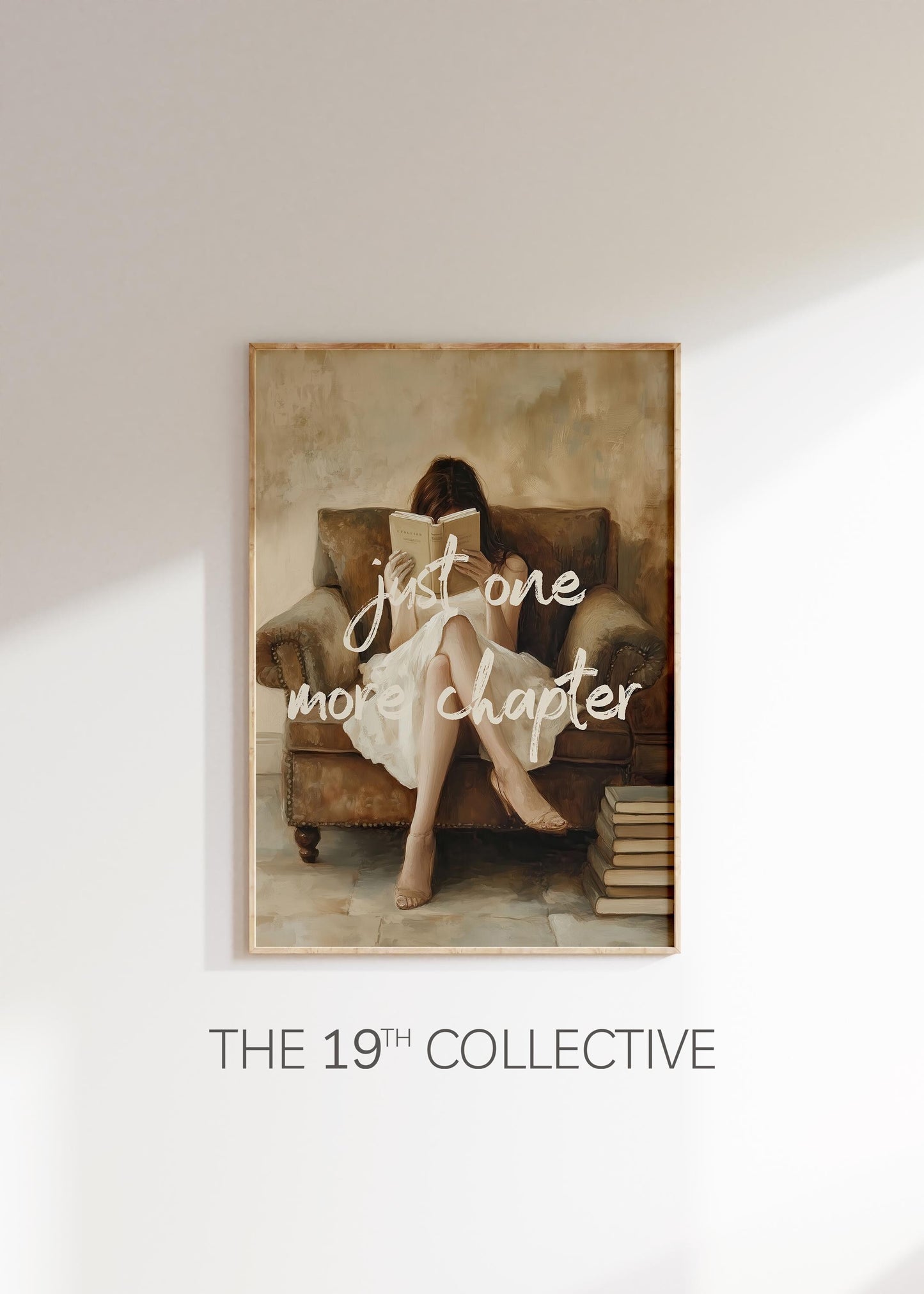 Framed art print of a woman sitting in a cozy armchair reading a book, with the phrase “just one more chapter” in soft white script across the image; warm, neutral tones and vintage-style painting effect