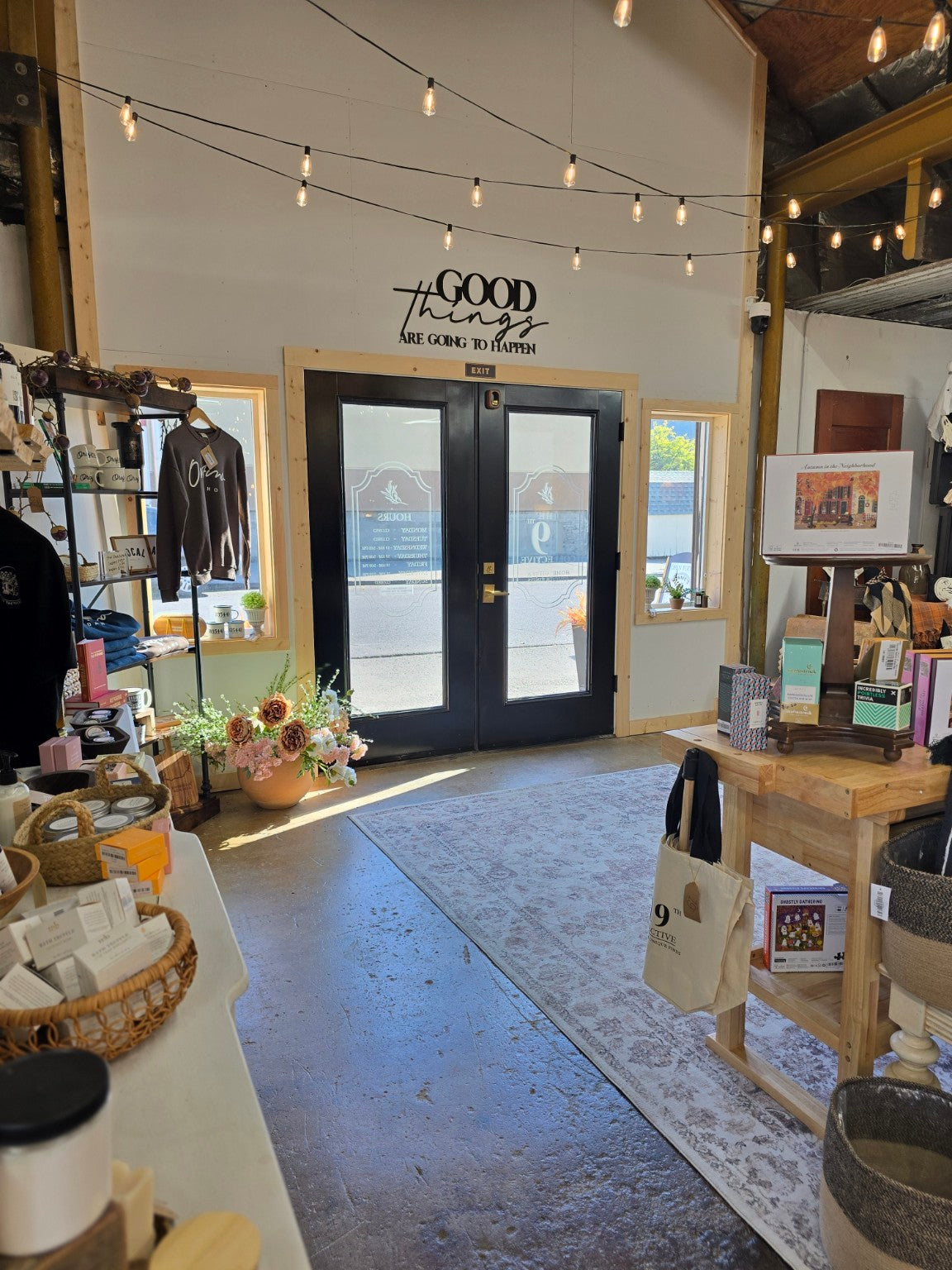 Inside The 19th Collective in Orofino, Idaho, with string lights, gifts, and black double doors.