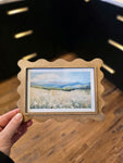 Vintage wildflower landscape art print in a handcrafted scalloped wood frame, perfect for rustic and cottagecore home decor