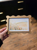 Vintage wheat field landscape print in a handcrafted scalloped wood frame, ideal for farmhouse and cottagecore home decor.