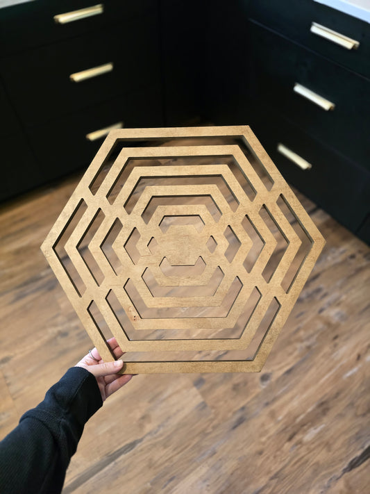 Hexagon-shaped geometric wood wall art in weathered stain.