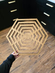 Hexagon-shaped geometric wood wall art in weathered stain.