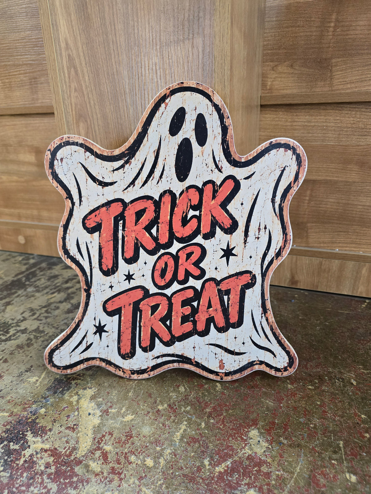 Vintage Trick or Treat ghost Halloween sign with distressed cream, black and orange artwork printed on wood.