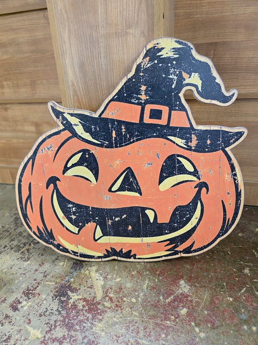 Vintage jack-o’-lantern Halloween wood sign with smiling pumpkin, black witch hat and distressed orange, black and cream artwork.