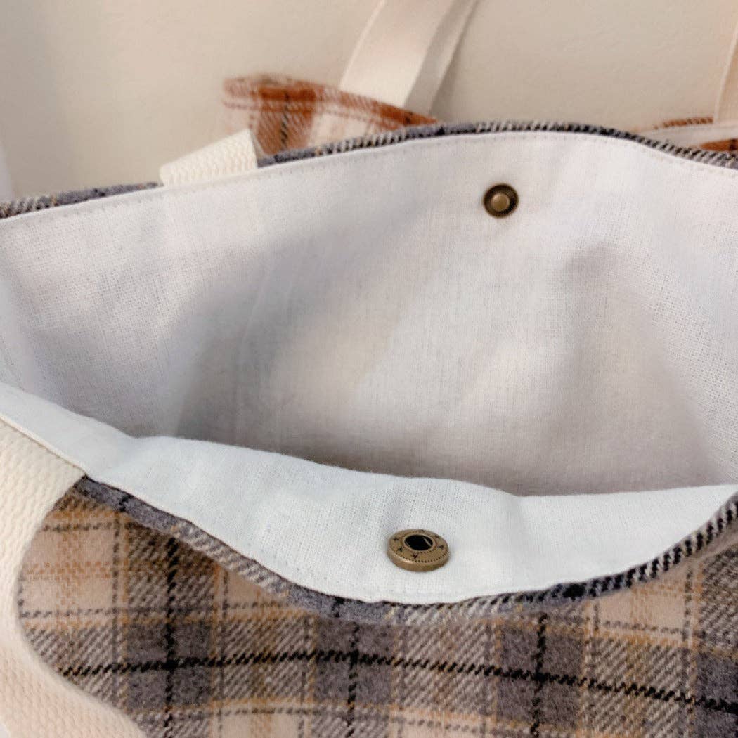 Interior of checkered handbag with snap closure.