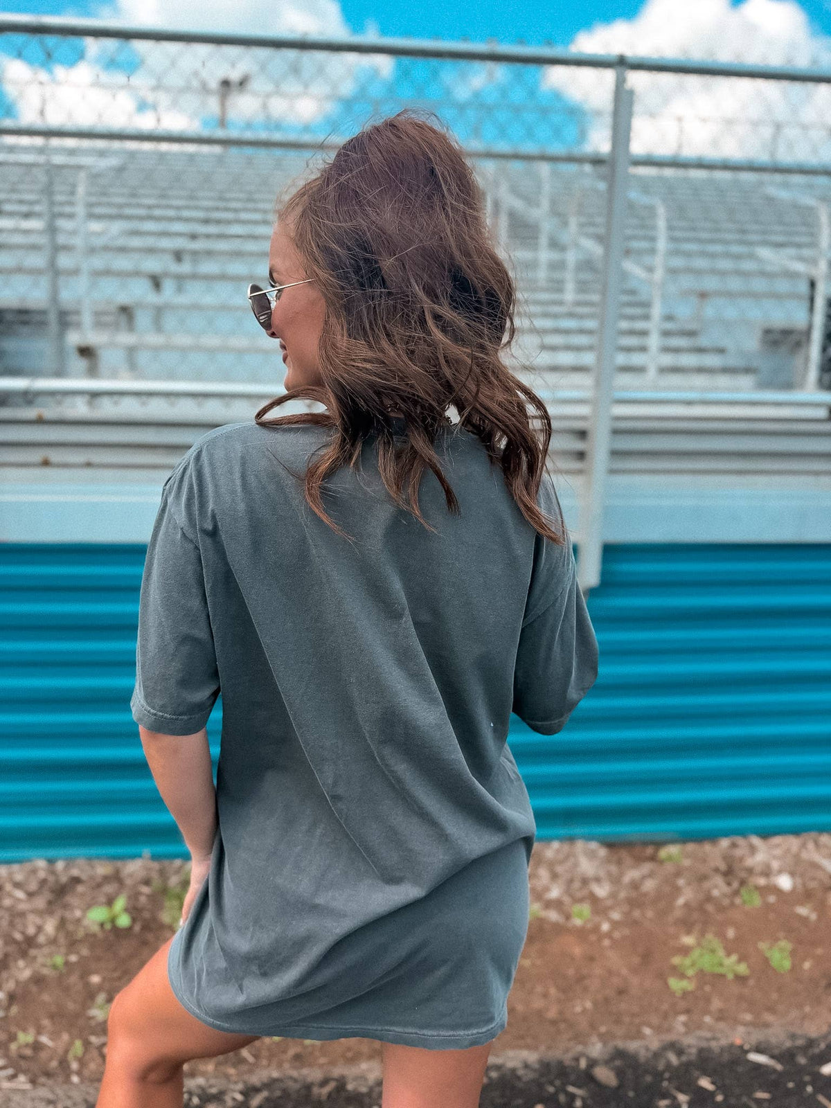 Back view of pepper-colored retro football graphic tee.