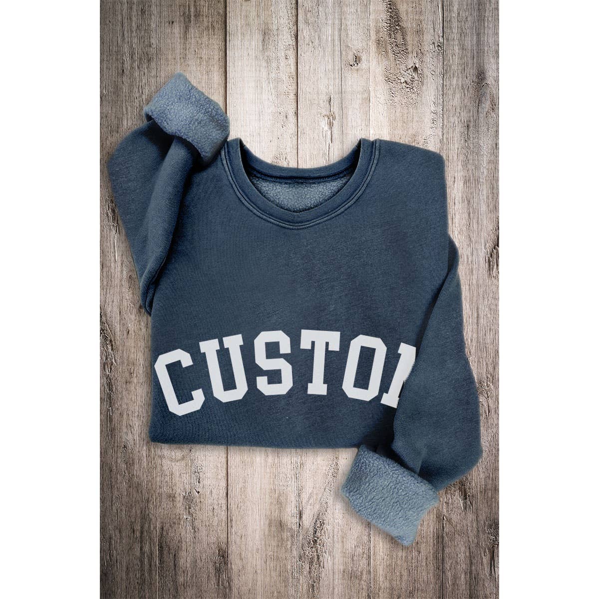 Navy mineral-wash sweatshirt shown folded with sample lettering.